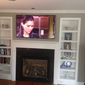 Oneclick - Another beautiful oneCLiCK TV mounted over fireplace. - Home Theatre Installation Near Me