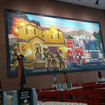 Firehouse Subs - Not sure if the guy on the right is shooting flames at the guy in the door or what? - Sandwiches Near Me - Phoenix, Arizona