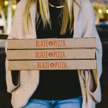 Blaze Pizza - a woman holding three pizza boxes - Salad Near Me - Charlottetown, Prince Edward Island Blaze Pizza - a woman holding three pizza boxes - Salad Near Me - Charlottetown, Prince Edward Island