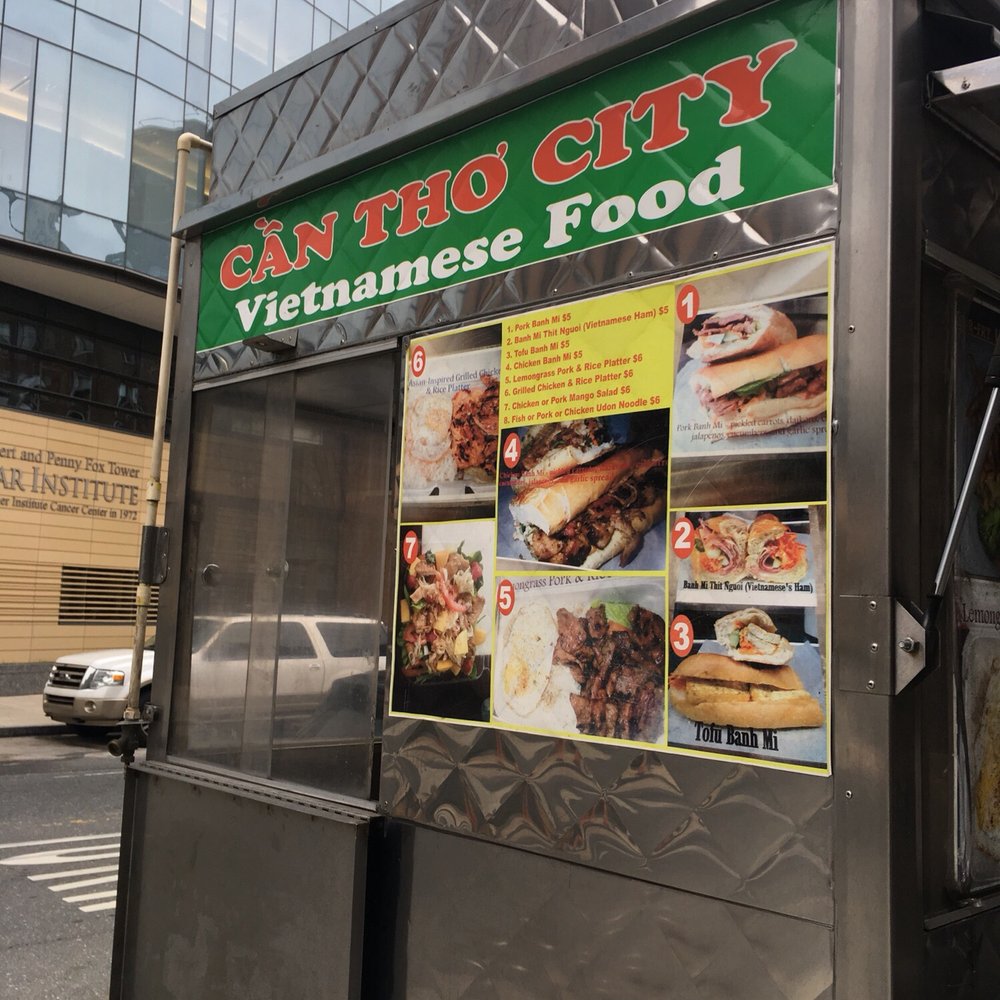 a vietnamese food stand on a city street a vietnamese food stand on a city street
