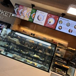 Coffee bar and baked goods case featuring so many delicious empanadas and other tasty offerings