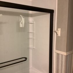 Bath Fitter - Sliding glass doors and built-in shelving.