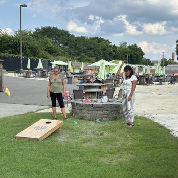 Main Line Brewery - Corn hole and outside picnic tables with umbrellas - Breweries Near Me - Richmond, Virginia Main Line Brewery - Corn hole and outside picnic tables with umbrellas - Breweries Near Me - Richmond, Virginia