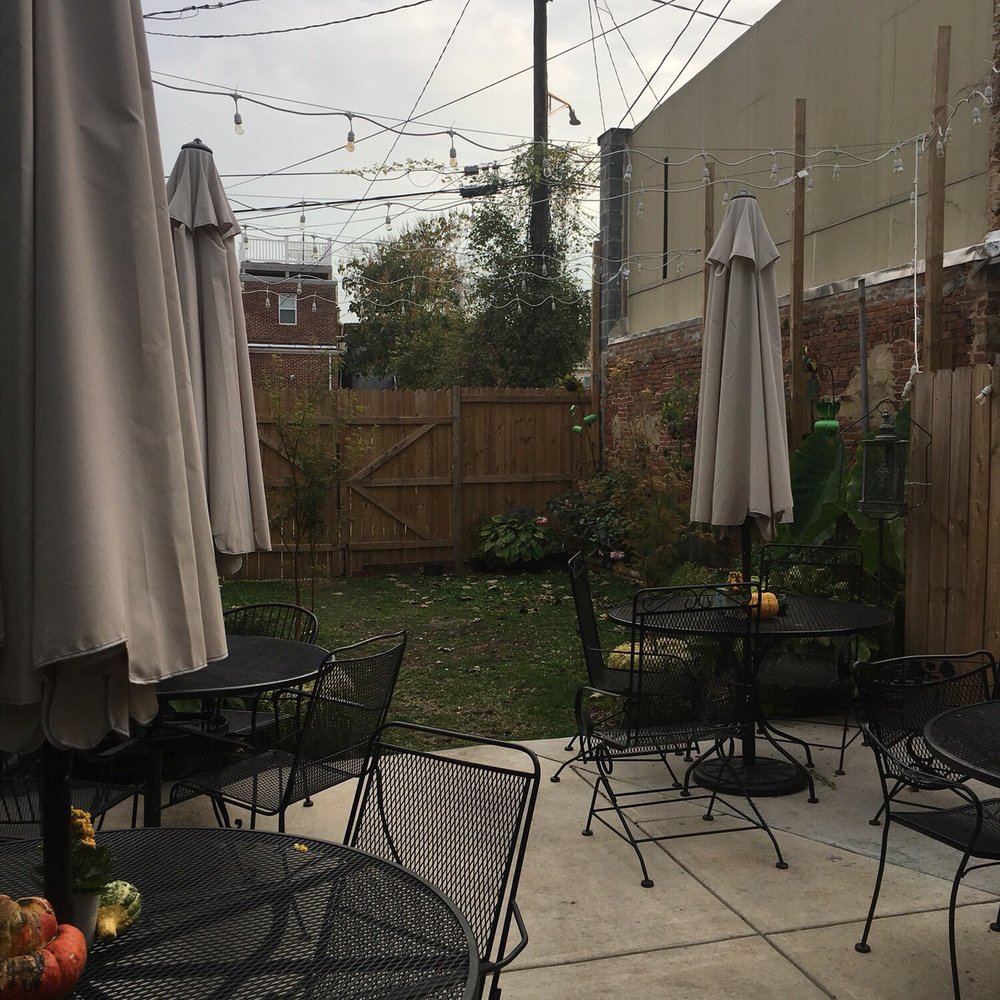 Culinary Architecture - Super cute backyard seating with greenery and hanging lights. - Specialty Food Near Me - Baltimore, Maryland Culinary Architecture - Super cute backyard seating with greenery and hanging lights. - Specialty Food Near Me - Baltimore, Maryland