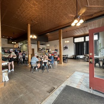 Sugarlump - Interior shot of Sugarlump from the front entrance area - Sugarlump coffee and gift shop interior with customers sitting at tables, browsing merchandise, and ordering at the counter. - Coffee & Tea Near Me - Westcliffe, Colorado