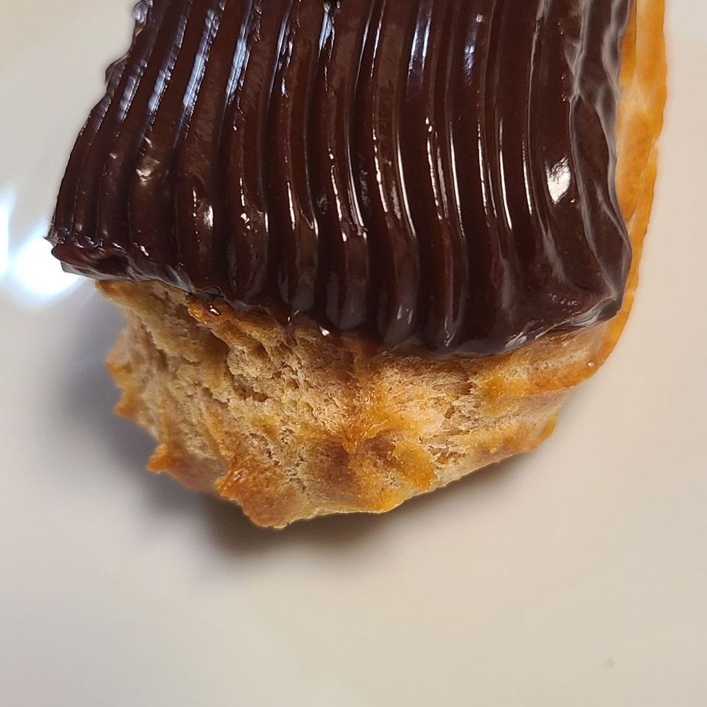 The Brooklyn Bakery - a chocolate frosted donut on a white plate - Bakeries Near Me - Palm Harbor, Florida The Brooklyn Bakery - a chocolate frosted donut on a white plate - Bakeries Near Me - Palm Harbor, Florida