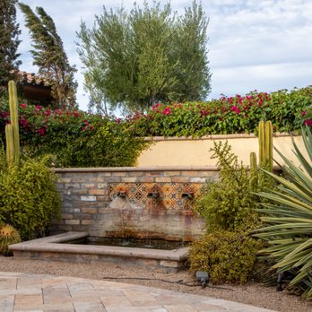 Pristine Green - Custom hardscape design with a beautiful water feature, adding style and tranquility to a Queen Creek outdoor living space. - Tree Services Near Me - Gilbert, Arizona