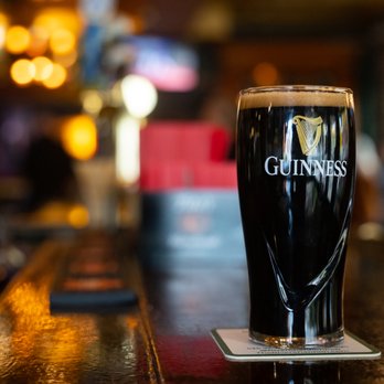 River Shannon - a pint of guinness on a bar - Irish Pub Near Me - Chicago, Illinois