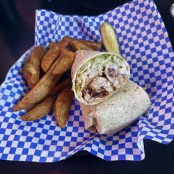 Bushwood Sports Bar and Grill - Chicken Bacon Ranch Wrap with potatoe wedges. Lunch special on Thursday $8.99