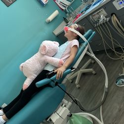Just For Grins Kids and Family Dental and Orthodontics - Weighted piggy to help her calm down.