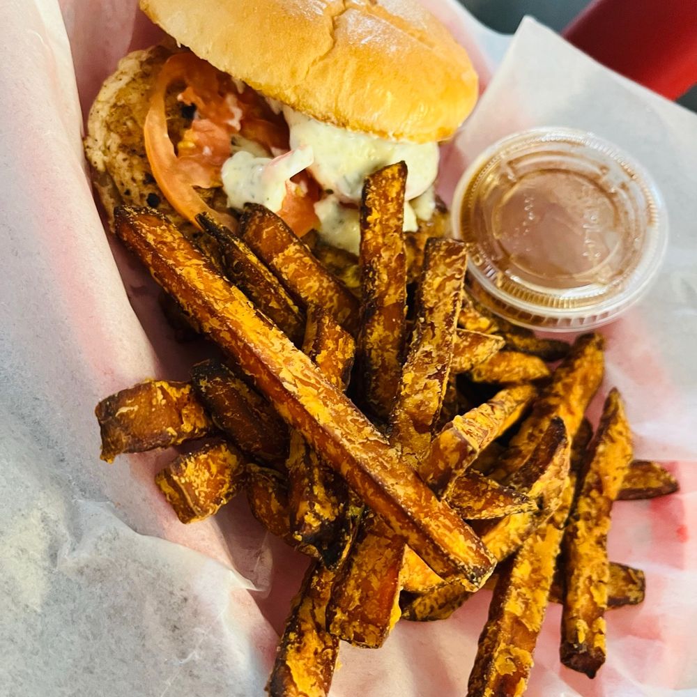 Italian grilled chicken sandwich with sweet potato fries and cinnamon honey. Italian grilled chicken sandwich with sweet potato fries and cinnamon honey.