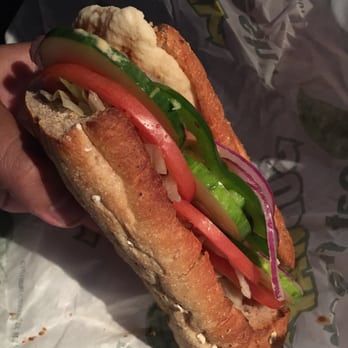 Subway - a person holding a sandwich in their hand - Sandwiches Near Me - Peru, New York Subway - a person holding a sandwich in their hand - Sandwiches Near Me - Peru, New York