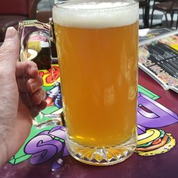 a person holding a glass of beer a person holding a glass of beer