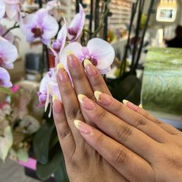 French tip nails with a bee design French tip nails with a bee design