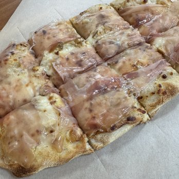 Pinsa 104 - Pinsa without sauce. Mozzarella, Gorgonzola, honey, walnuts, and speck. - Pizza Near Me - Davie, Florida