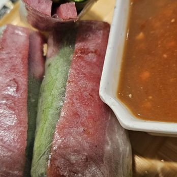 Pho Viet Cali - Nem nướng cuốn: Cut open. A raw spring roll containing a slice of leathery, grilled, salty, porky sausage - Vietnamese Near Me - Reseda, California Pho Viet Cali - Nem nướng cuốn: Cut open. A raw spring roll containing a slice of leathery, grilled, salty, porky sausage - Vietnamese Near Me - Reseda, California