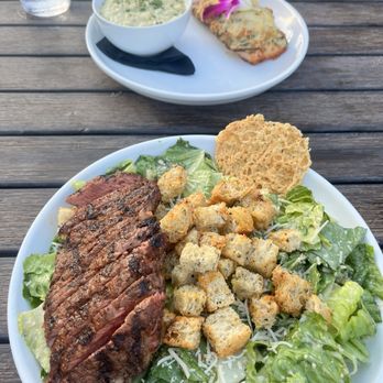 Roots Seasonal Cuisine - STEAK CAESAR and CRAB STUFFED SALMON with HERBED RISOTTO in the back - New American Near Me - Lee's Summit, Missouri