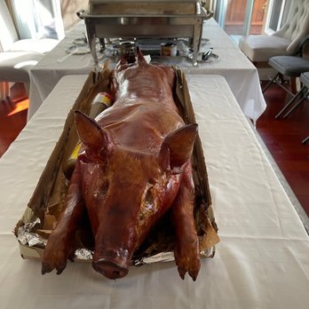 Lechon Palace - a roasting pig on a table - Specialty Food Near Me Lechon Palace - a roasting pig on a table - Specialty Food Near Me