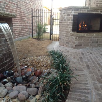 Seasons Outdoor Living - a brick patio with a fire place - Landscaping Near Me Seasons Outdoor Living - a brick patio with a fire place - Landscaping Near Me