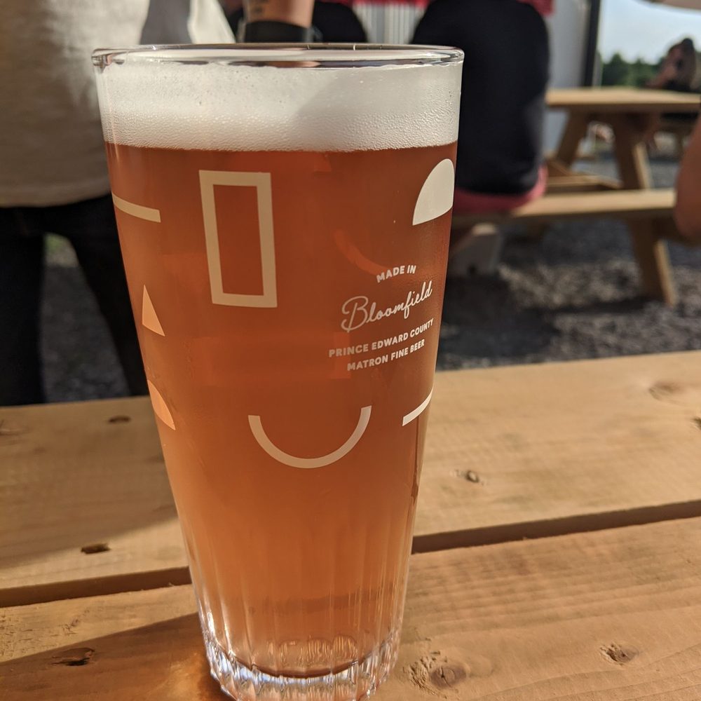 Matron Fine Beer - a glass of beer on a table - Breweries Near Me - Bloomfield, Ontario