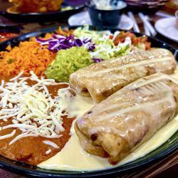 Plaza Del Mariachi - Chimichangas (Beef and Chicken) with refried beans, rice, and a salad with guacamole and sour cream.