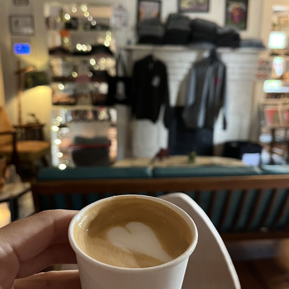 a person holding a cup of coffee a person holding a cup of coffee