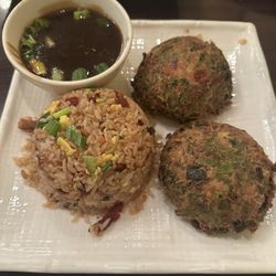 MAI Little China - This is egg foo yung. Notice the very dark gravy. Also how dark the egg is.   I'm guessing they burnt the oil.