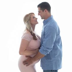 Beautiful new mom Christina in pink lace maternity gown posed with husband Jamie against backllight for maternity photos Gainesville Florida