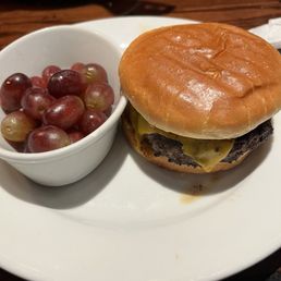 Kid's meal: cheeseburger and grapes Kid's meal: cheeseburger and grapes