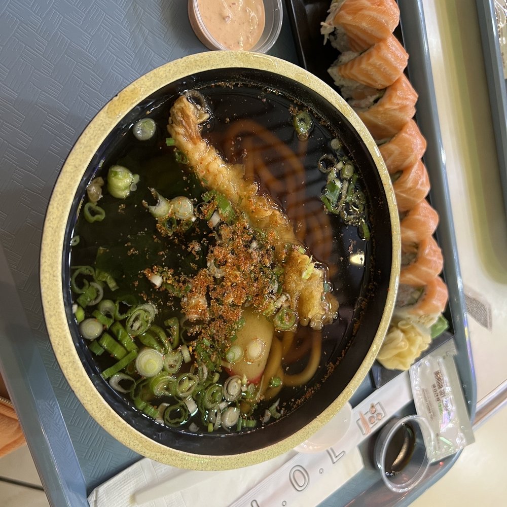 a bowl of soup and a tray of sushi a bowl of soup and a tray of sushi