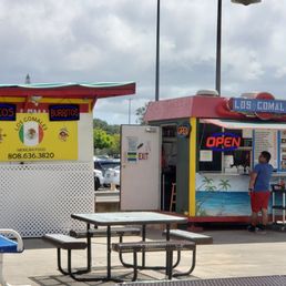 a man ordering food from a food truck a man ordering food from a food truck