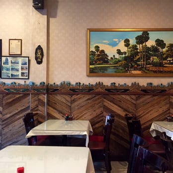 Phnom Penh House - Interior tables and wall tapestry. - Cambodian Near Me - Alameda, California Phnom Penh House - Interior tables and wall tapestry. - Cambodian Near Me - Alameda, California