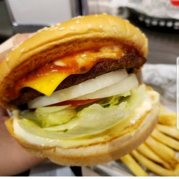 Carl's Jr - a hand holding a cheeseburger and fries - Fast Food Near Me - Lehi, Utah