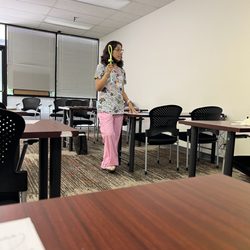 International College of Health Sciences - Professor lopez holding up something brand new that hasn't even been to a hospital floor yet