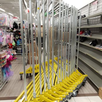 Burlington - Just wow - Multiple yellow shopping carts with metal handles are lined up in an aisle of a retail store, surrounded by shelves with shoes and toys. - Department Stores Near Me - Poughkeepsie, New York