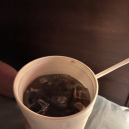 a person holding a cup of ice tea a person holding a cup of ice tea