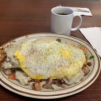 The Corner Cafe - Breakfast Scramble. Biscuit smother with country gravy, sausage, hash browns,peppers onion and tomato. Topped off with an over-easy egg. - Breakfast & Brunch Near Me - Post Falls, Idaho The Corner Cafe - Breakfast Scramble. Biscuit smother with country gravy, sausage, hash browns,peppers onion and tomato. Topped off with an over-easy egg. - Breakfast & Brunch Near Me - Post Falls, Idaho
