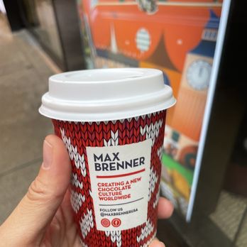 Max Brenner Times square - Chocolate Shop - a hand holding a cup of coffee - Chocolatiers & Shops Near Me - New York, New York Max Brenner Times square - Chocolate Shop - a hand holding a cup of coffee - Chocolatiers & Shops Near Me - New York, New York