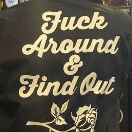 the back of a woman's jacket with a rose on it