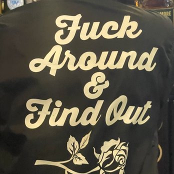 Nancy Whiskey - the back of a woman's jacket with a rose on it - Pubs Near Me - Detroit, Michigan