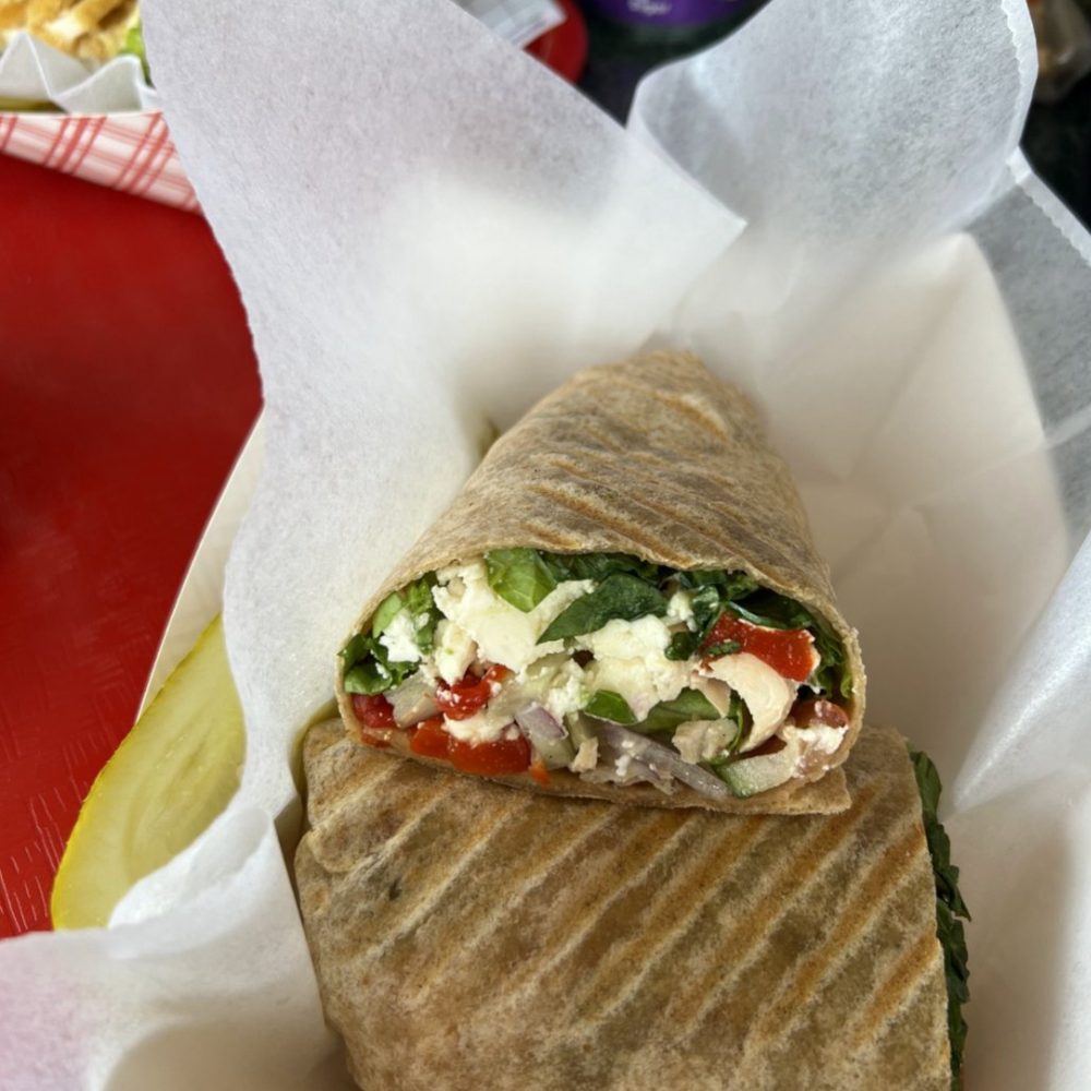 a wrap with vegetables and cheese a wrap with vegetables and cheese