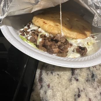 Jefes Tacos & Catering - a sandwich wrapped in foil - Mexican Near Me - Austin, Texas