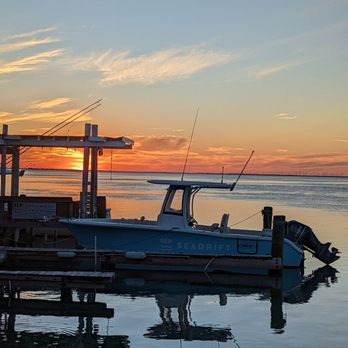 Laguna BoB - a boat docked at a dock at sunset - American Near Me - South Padre Island, Texas