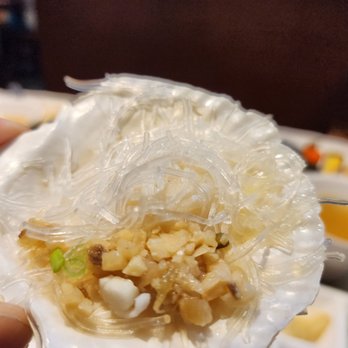 Sushi Legend - a person holding a piece of food - Japanese Near Me - North York, Ontario Sushi Legend - a person holding a piece of food - Japanese Near Me - North York, Ontario