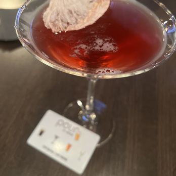 Top Shelf Tavern - a glass of red liquid with a flower on it - Wine Bars Near Me - West Fargo, North Dakota Top Shelf Tavern - a glass of red liquid with a flower on it - Wine Bars Near Me - West Fargo, North Dakota