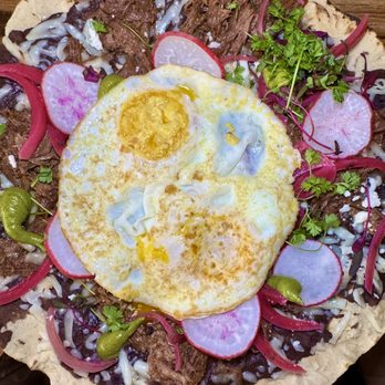 Cocina De Barrio - "Tlayuda" ($21.95) Large thin crunchy tortilla, refried beans, Beef Birria, queso Oaxaca, avocado mousse, fried eggs - Breakfast & Brunch Near Me - San Diego, California Cocina De Barrio - "Tlayuda" ($21.95) Large thin crunchy tortilla, refried beans, Beef Birria, queso Oaxaca, avocado mousse, fried eggs - Breakfast & Brunch Near Me - San Diego, California