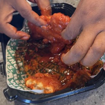 Wingstop - If you zoom in on the bitten piece, you can see the raw chicken - Chicken Wings Near Me - Upland, California Wingstop - If you zoom in on the bitten piece, you can see the raw chicken - Chicken Wings Near Me - Upland, California