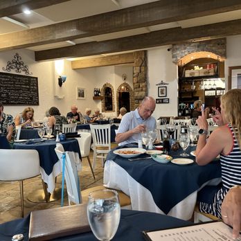 Dolce Italia - a group of people eating at a restaurant - Italian Near Me - Sarasota, Florida Dolce Italia - a group of people eating at a restaurant - Italian Near Me - Sarasota, Florida