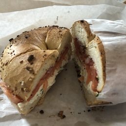 Slightly toasted everything bagel with scallion cream cheese, tomatoes, onions, and lox Slightly toasted everything bagel with scallion cream cheese, tomatoes, onions, and lox