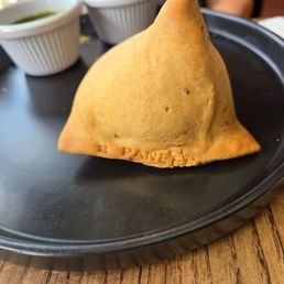 A Paneer Samosa stamped with "Paneer."